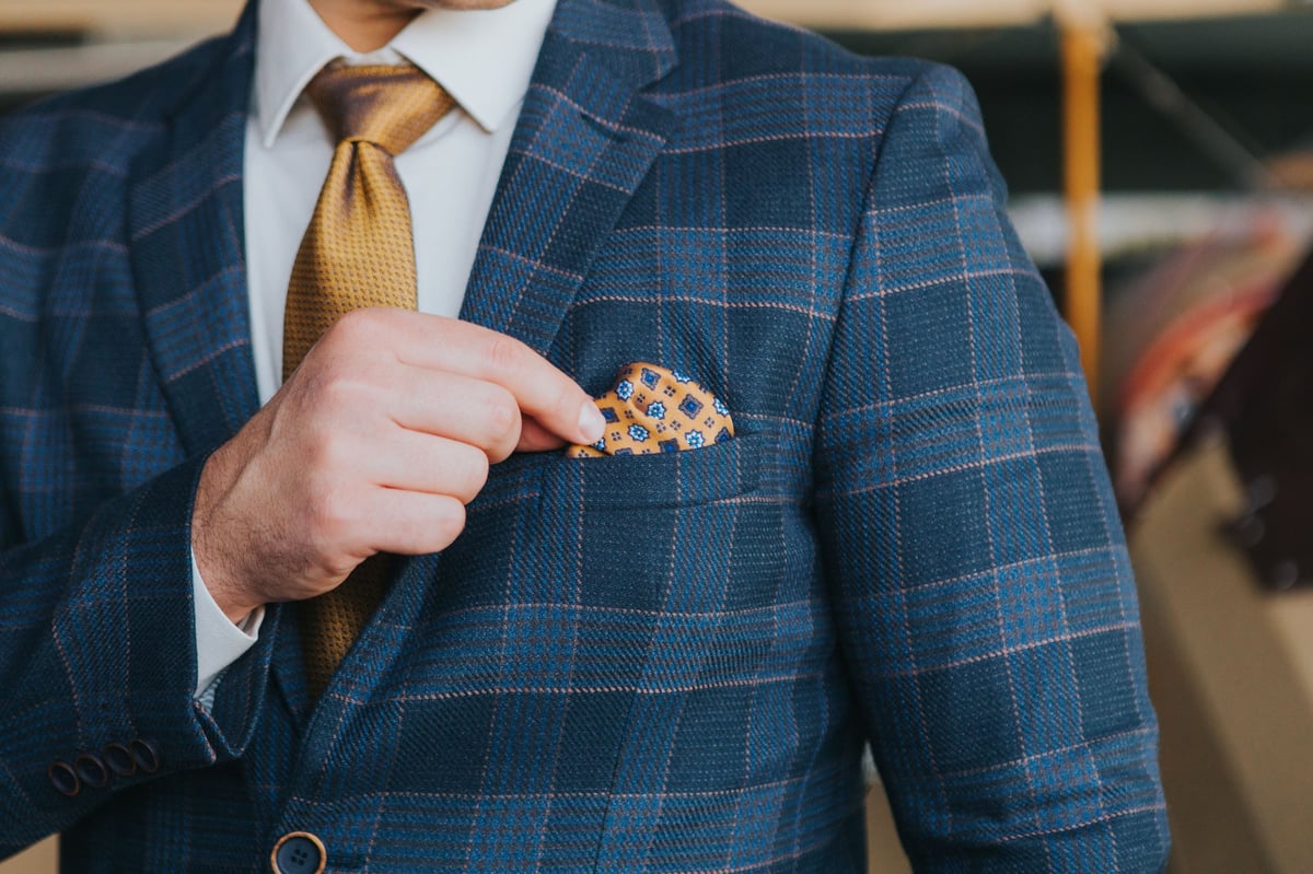 Close-up of man wearing blue plaid tailored suit
