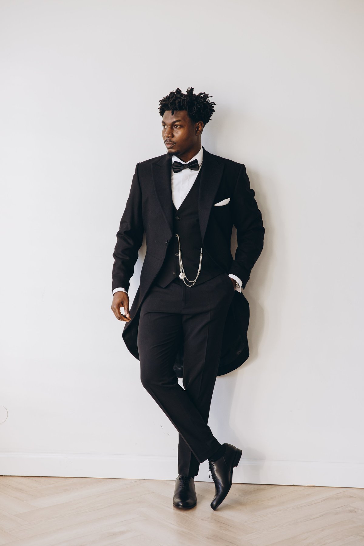 Stylish African groom in sleek tuxedo and bow tie exuding elegance