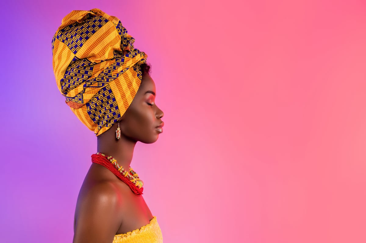 Stunning African woman in profile wearing elegant traditional outfit