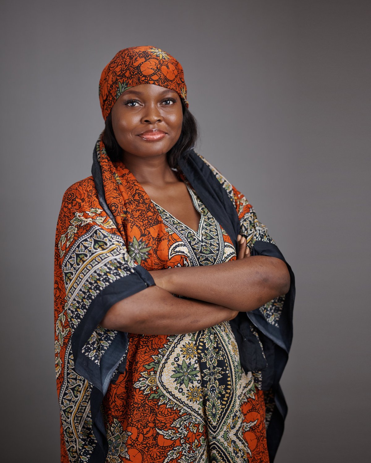Young black woman wearing patterned traditional dress and matching headscarf