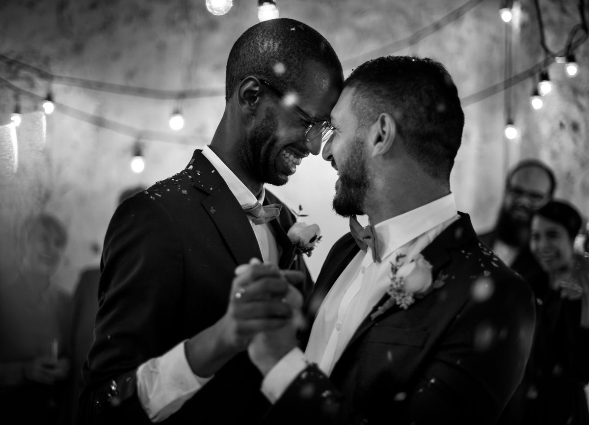 Newlywed couple dancing at wedding celebration in elegant formal attire
